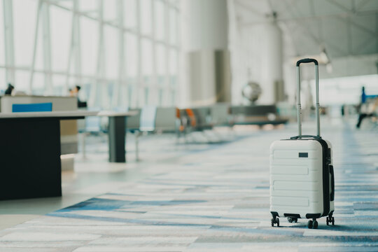 The suitcases in an empty airport hall, traveler cases in the departure airport terminal waiting for the area, vacation concept, blank space for text message or design