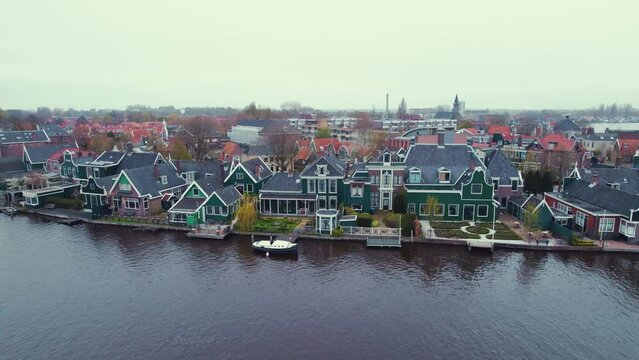 Old traditional wooden houses along the river at the Zaanse Schans, Koog aan de Zaan, Netherlands. High quality 4k footage
