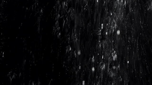 Splashing liquid on window with a black background