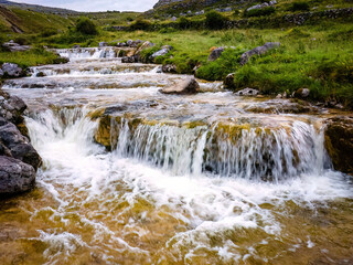 Peaceful cascade river flow irish landscape in summer