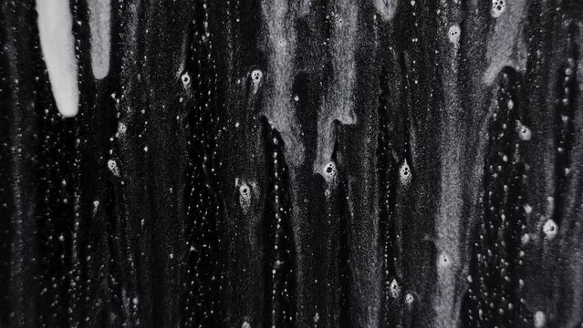 Foam bubbles on a glass on a black background