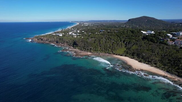 Lush Forest Trees At The Bay Of Coolum Beach In The Sunshine Coast, QLD Australia. Aerial Shot