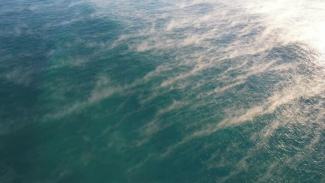 Sea Fog Rising Over Blue Waters In Coolum Beach During Sunrise In QLD, Australia. - aerial pullback