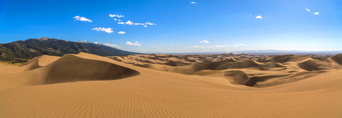 Great Sand Dunes - A panoramic view at top of Great Sand Dunes, looking from east towards north-west, on a sunny but windy Spring evening. Great Sand Dunes National Park & Preserve, Colorado, USA.