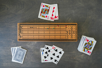 Overhead view of cribbage board and cards