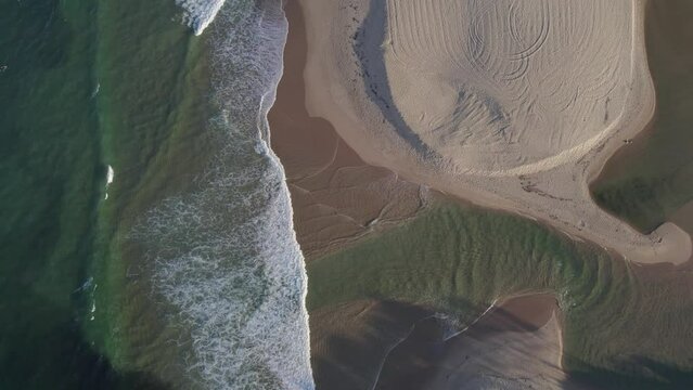 Foamy Waves of the Ocean Splashing on the Beach by Currimundi Creek, Sunshine Coast, Queensland, Australia Aerial Shot