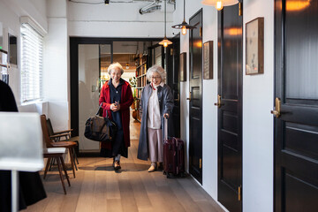 ホテルの廊下を歩くシニア女性