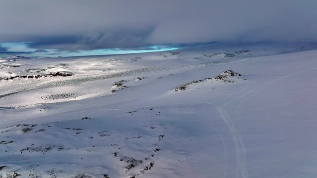 Aerial panoramic landscape view of Myrdalsjokull glacier covered in snow in Iceland, on a cloudy evening