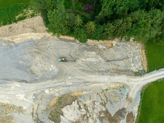 Aerial view of bulldozer on construction site and mining industry. Heavy machinery for earth moving.