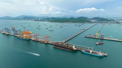 Foto op Canvas small distribution port in sea and pedestrian bridge to conect between islands and oil tankers ship floating in sea © SHUTTER DIN