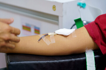 man as blood donor at donation with a bouncy ball holding in hand