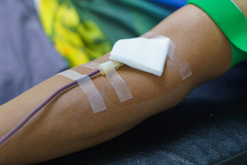 man as blood donor at donation with a bouncy ball holding in hand