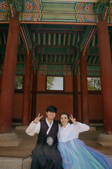 Tourist couple wearing a traditional korean hanbok at the Changgyeonggung Palace, Seoul, South Korea.