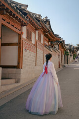 Obraz premium Tourist girl wearing a traditional korean hanbok at the Hanok Village in Seoul, South Korea.