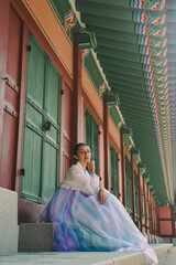 Tourist girl wearing a traditional korean hanbok at the Changgyeonggung Palace, Seoul, South Korea.