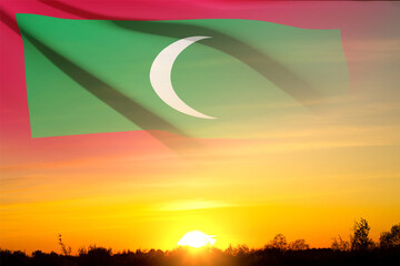 Flag on Maldives with transparency against the sunset. Background for National Holidays
