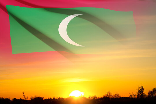 Flag on Maldives with transparency against the sunset. Background for National Holidays