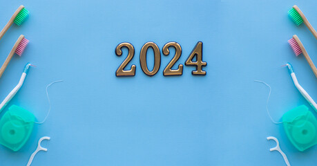 2024 and dental concept. Close up view of photo with 2024, dental floss, floss stick and wooden...