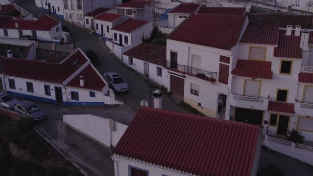 Tilt up shot of Odeceixe with famous windmill in the center, aerial