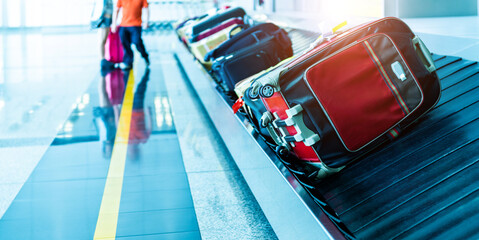 Many suitcases on conveyor belt of airport