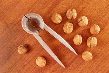 Walnuts are split with a nutcracker. Kitchen appliances for work in the kitchen.