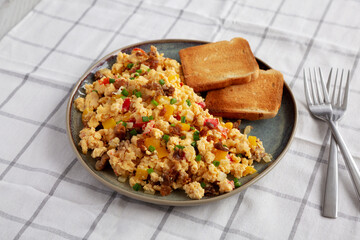 Homemade Fiesta Scrambled Eggs with Peppers and Toast on a Plate, side view.