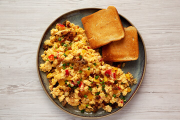 Homemade Fiesta Scrambled Eggs with Peppers and Toast on a Plate, top view. Flat lay, overhead, from above.