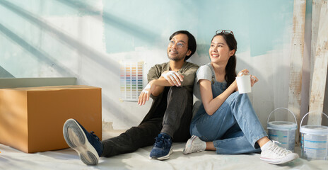 New home,Repair,happy,New life,insurance,carefree relationship,love lifestyle,new apartment,renovation and decorating concept.Young asian couple choosing blue color.happy smiling asian couple in home