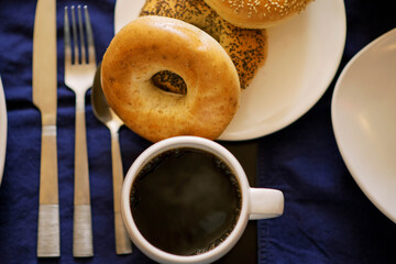 Inviting plate of fresh bagels and black coffee