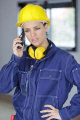troubled female builder using walkie talkie