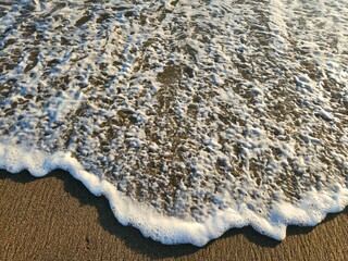 Warm Wave Blanketing Textured Sand