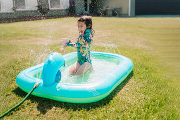 Toddler Girl Playing In Yard Pool