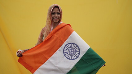 Indian woman waving indian tricolour flag outdoor park, conceptual image for republic day or...