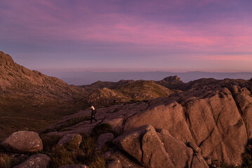 Beautiful view to man hiking on rocky mountains and altitude fields