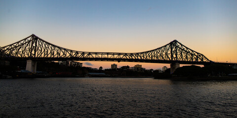 famous story bridge in brisbane at sunset; red sunset over brisbane cbd, queensland, australia	