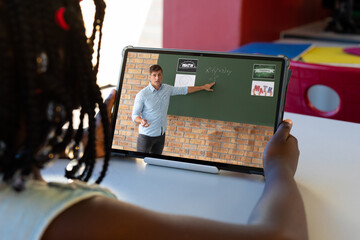 African american girl looking at male teacher explaining to her through video call on laptop