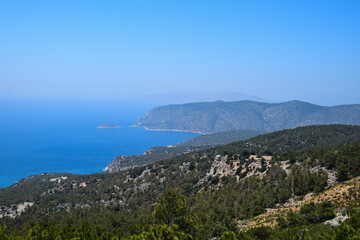 Fototapeta na wymiar sea view on a clear summer day full of sun. Panorama of the island of Rhodes.