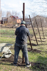 Workers install a metal profile fence