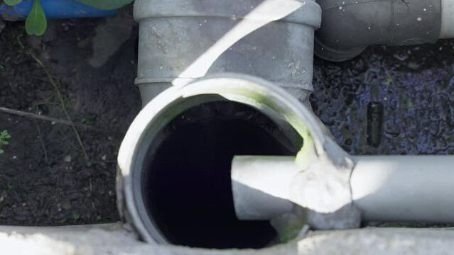 Inside the old plastic sewer pipe, sewage or toilet waste water flows down