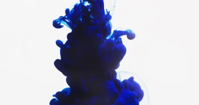 Slow motion video of blue watercolor ink mixing in water against grey background