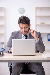 Young male employee working in the office