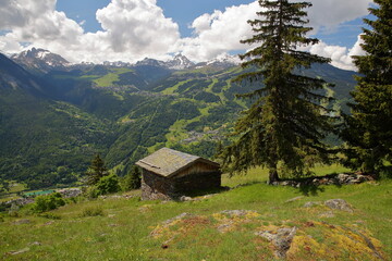 Fototapeta na wymiar Panoramic view from a hiking trail above Bozel towards the ski resort Courchevel, Northern French Alps, Tarentaise, Savoie, France, surrounded by mountains and glaciers