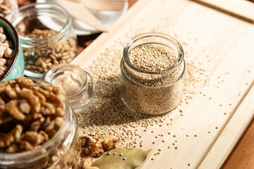 Fototapeta na wymiar small jar with quinoa on rustic table top view. Healthy food and snack.