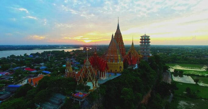 .Aerial view beautiful Tham Suea temple is another famous place and is a major tourist attraction of Kanchanaburi. .Amazing temple on hilltop in beautiful sunrise. Unimaginable beauty background.