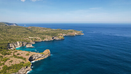 Aerial view of a person along the whole sand beach coastline, Nusa Penida. Bali