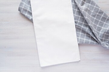 White plain fabric kitchen towel or napkin mockup, place for design or logo presentation, minimal composition with checkered grey table cloth.