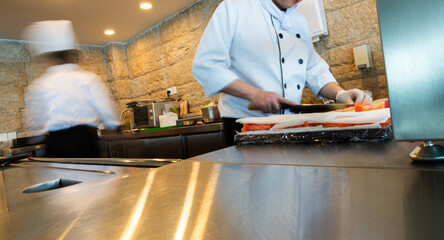 Japanese chef making sashimi in the kitchen