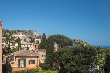 Fototapeta na wymiar Photograph of houses in Taormina, Sicily, houses, trees, flowers