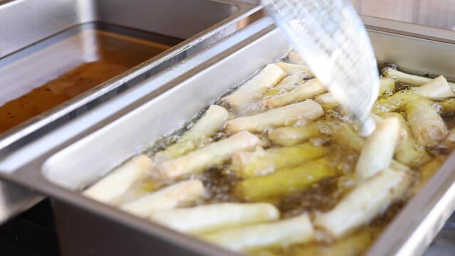 Close Up Of Egg Rolls Being Deap Fried