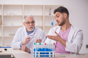 Two male chemists working at the lab